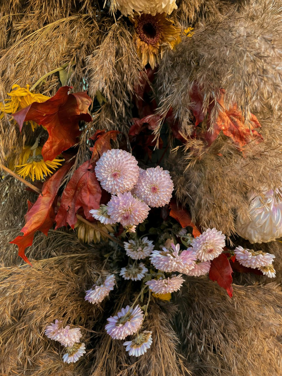 Autumn dried flowers and soft pink blooms arranged for a commercial space