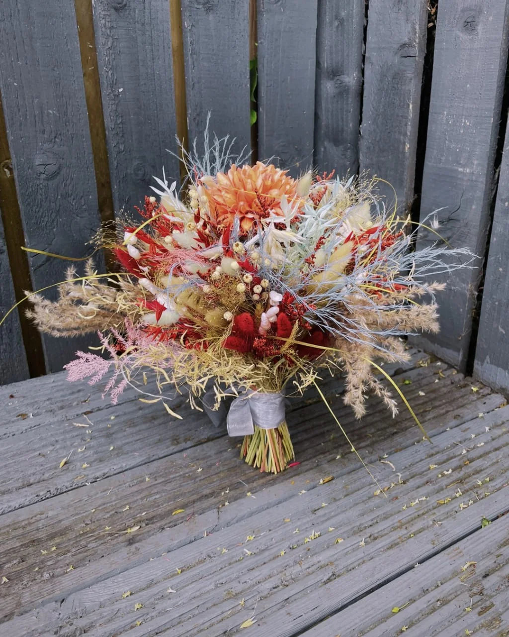 Coral, cream and pale blue dried-flower bridal bouquet