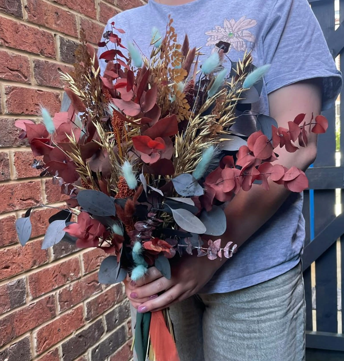 A warm-toned dried flower wedding bouquet by Petal Ritual