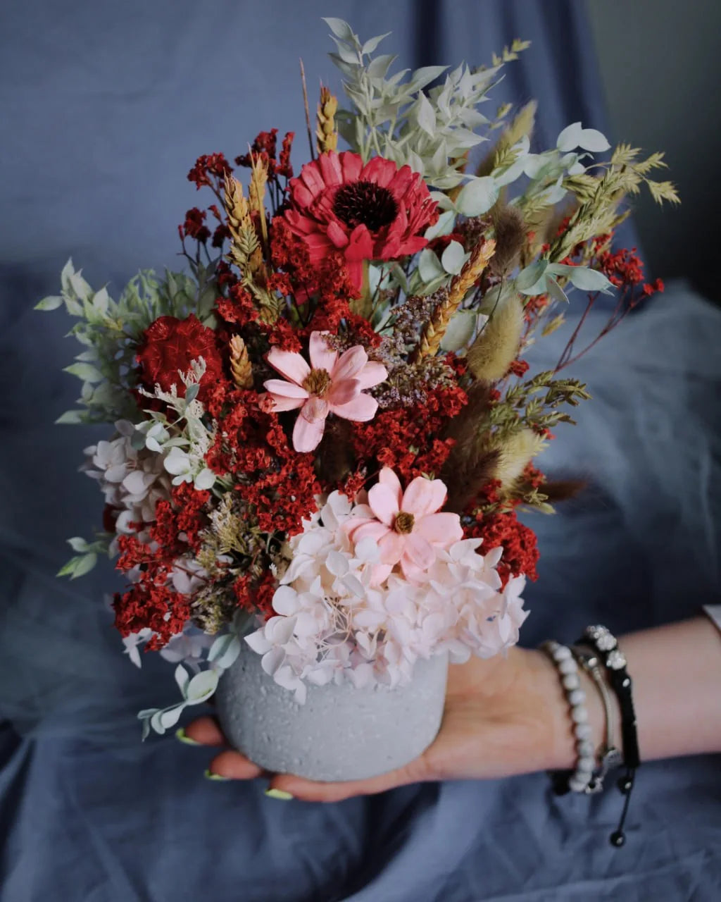 Red and blush dried-flower wedding table arrangement